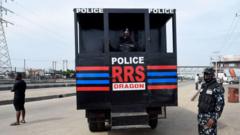 Police Rapid Response Squad RRS officer stand near RRS truck truck