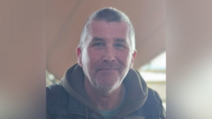 A man with dark hair looking at the camera