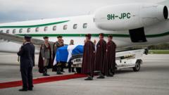 Alex Salmond's coffin on flight back to Scotland