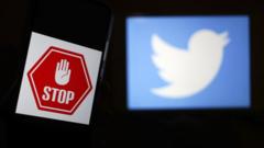 A stop sign next to the Twitter logo