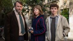 L-R: John ‘Ludwig’ Taylor (DAVID MITCHELL); Lucy Betts-Taylor (ANNA MAXWELL MARTIN); Henry Betts-Taylor (DYLAN HUGHES)