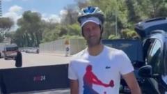 Djokovic dons a helmet after being hit by bottle