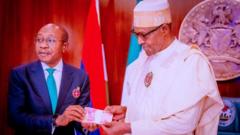 CBN Govnor Godwin Emefiele and President Buhari wit di new note