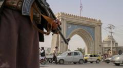 Taliban fighter stands guard at a checkpoint in Kandahar, Afghanistan, 17 August 2021.