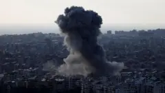 Smoke billows over Beirut's southern suburbs following Israeli strike.