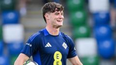 Who is Uncapped McMullan Taking Charles' Place in the NI Squad?