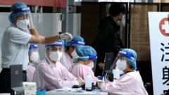 Staff in PPE waiting for people to get their inoculation at a popup walk-in COVID-19 vaccination center in Taipei Main station in Taipei, Taiwan, December 10, 2021.