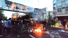 File photo showing people gathered around a fire during an anti-government protest sparked by the death of Mahsa Amini, in Tehran, Iran (21 September 2022)