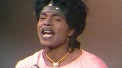 A close up of Little Richard speaking to the interviewer.