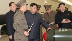 Kim Jong Un with what North Korean state media says are tactical nuclear weapons
