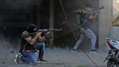 Shia militia fighters fire rifles and rocket-propelled grenades during clashes near the Palace of Justice in Beirut, Lebanon (14 October 2021)