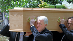 Wales legend Mark Hughes carries his son's coffin as he pays final respects
