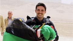 Jordanian Prince Hamzah bin al-Hussein, president of the Royal Aero Sports Club of Jordan, carries a parachute during a media event to announce the launch of "Skydive Jordan", in the Wadi Rum desert in April 2011