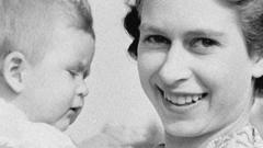 Queen Elizabeth II holding Prince Charles as a baby
