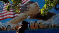 A man walks by a 9/11 memorial mural in the Bronx borough of New York City