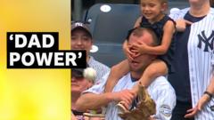 Watch: Fan catches ball while daughter covers his eyes