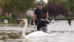 Cars and rail lines submerged as flood risk persists