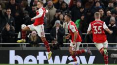 Arsenal dey celebrate dia second goal agaisnt Tottenham
