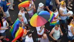 People march with their rainbow colors from the parliament building in Budapest downtown during the lesbian, gay, bisexual and transgender (LGBT) Pride Parade in the Hungarian capital