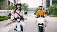 Two young people in Taiwan riding scooter motorbikes