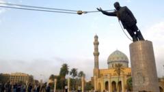 US Troops topple a statue of Saddam Hussein in Baghdad, April 9, 2003