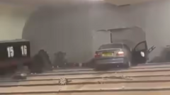 Man charged after car crashes through bowling alley