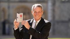 Liverpool legend Hansen receives MBE