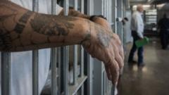 Prisoner's hands hang outside the bars