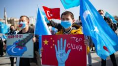 Members of the Muslim Uighur minority hold placards as they demonstrate to ask for news of their relatives and to express their concern about the ratification of an extradition treaty between China and Turkey at Uskudar square in Istanbul on February 26, 2021.