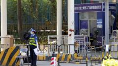 A security guard works at the entrance to another Foxconn factory, this one in Shenzhen, which was under strict access control last month due to Covid
