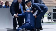 President Biden aides help to carry am back up afta e fall