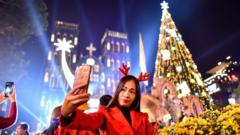 A woman takes a selfie outsideSt. Joseph"s cathedral in Hanoi on December 24, 2019.