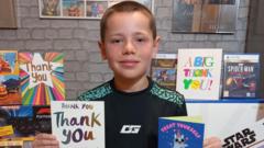 Boy, 8, showered with gifts after calming plane passenger with singing and football cards