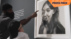 Kelvin Okafor and Andoni looking at portrait.