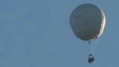 Why was a white balloon flying across the UK?