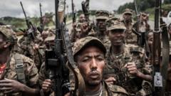 Ethiopian National Defence Forces (ENDF) soldiers dey shout slogans after dem finish dia training for di field of Dabat, 70 kilometres northeast of di city of Gondar, Ethiopia, on September 14, 2021