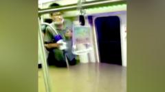 Man stands in flooded subway carriage, China