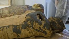 The mummy is seen lying down in place by casing