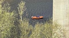 Woman bailed as river search for man continues