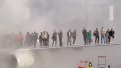 Watch: Passengers escape on to wing after plane catches fire