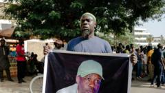 Un manifestant tient une banderole représentant l'opposant sénégalais détenu, Ousmane Sonko