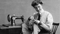 A seamstress using a Singer sewing machine in 1907