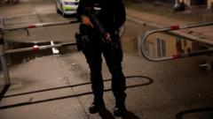 A Danish police officer holds a rifle