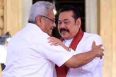 Sri Lankan president Gotabaya Rajapaksa(L) greets and receives blessings after handing over the appointment documents to his brother, former president, Mahinda Rajapaksa who took oaths as the prime minister at Kelaniya Raja Maha Viharaya, in Colombo, Sri Lanka on August 9, 2020.