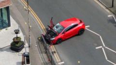 Man charged after car hits five people in town centre