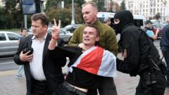A student flashes the victory sign as he is detained by law enforcement officers during a protest against presidential election results in Minsk, Belarus September 1, 2020