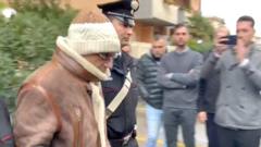 Messina Denaro being walked out of a Carabinieri police station after his arrest in Palermo, Italy