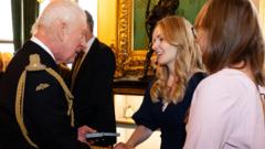 King presents Elizabeth Emblems to families of those who died on duty