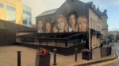 Derry Girls mural ‘split in half’ by bar awning