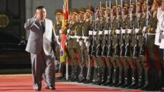 Kim Jong-un salutes as he walks past troops, Pyongyang (10 Oct)